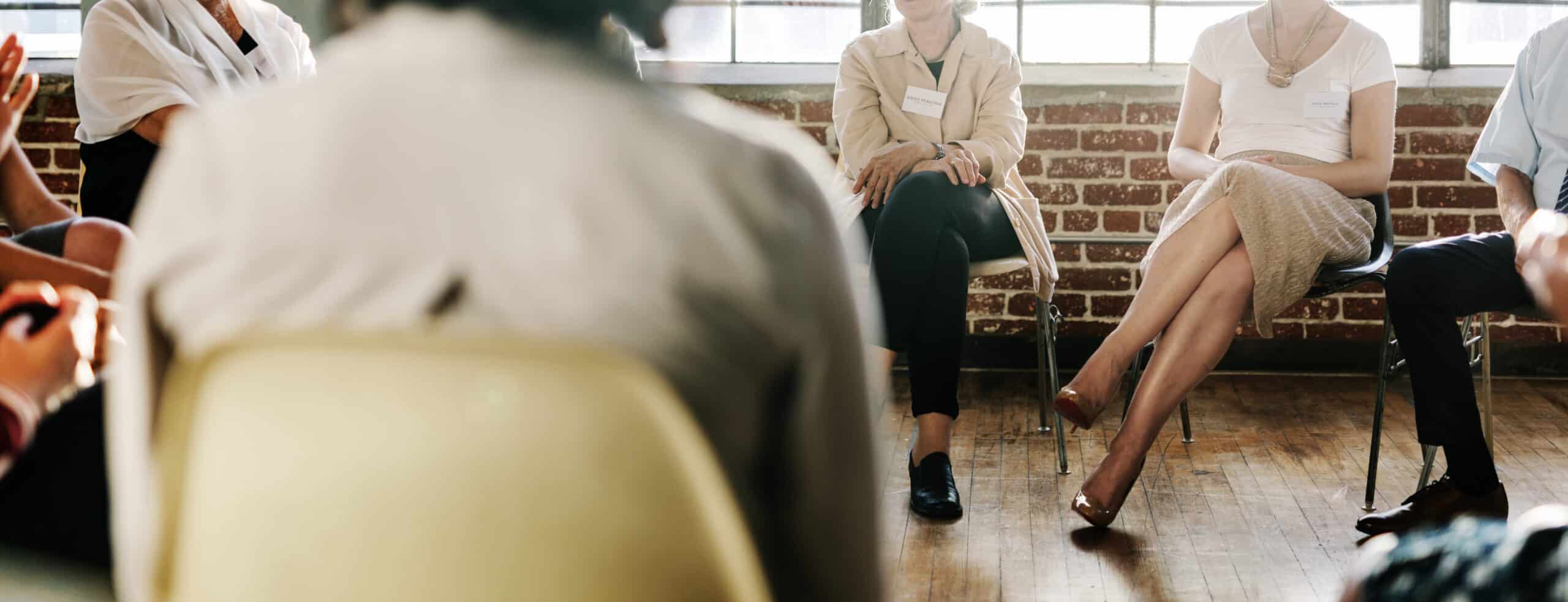 people in group therapy sitting in chairs