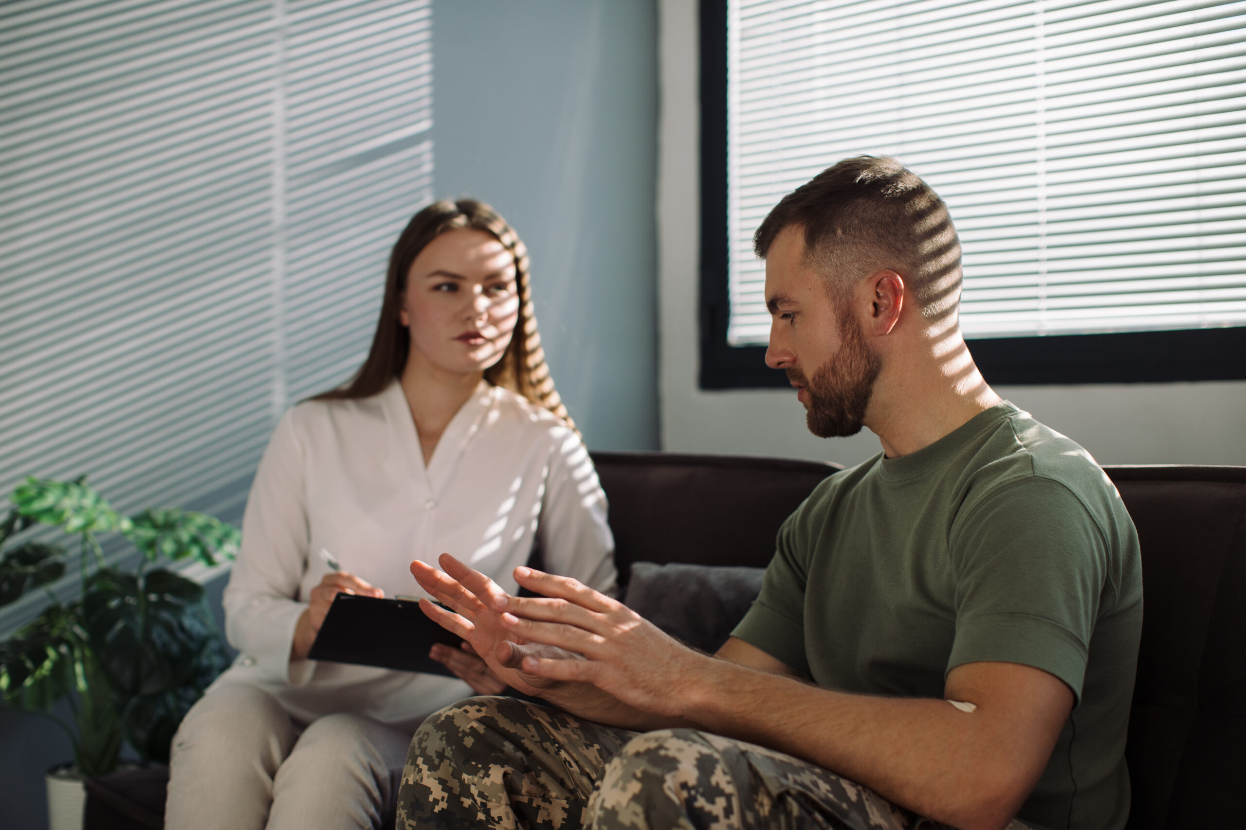 Psychotherapist working with military officer in office