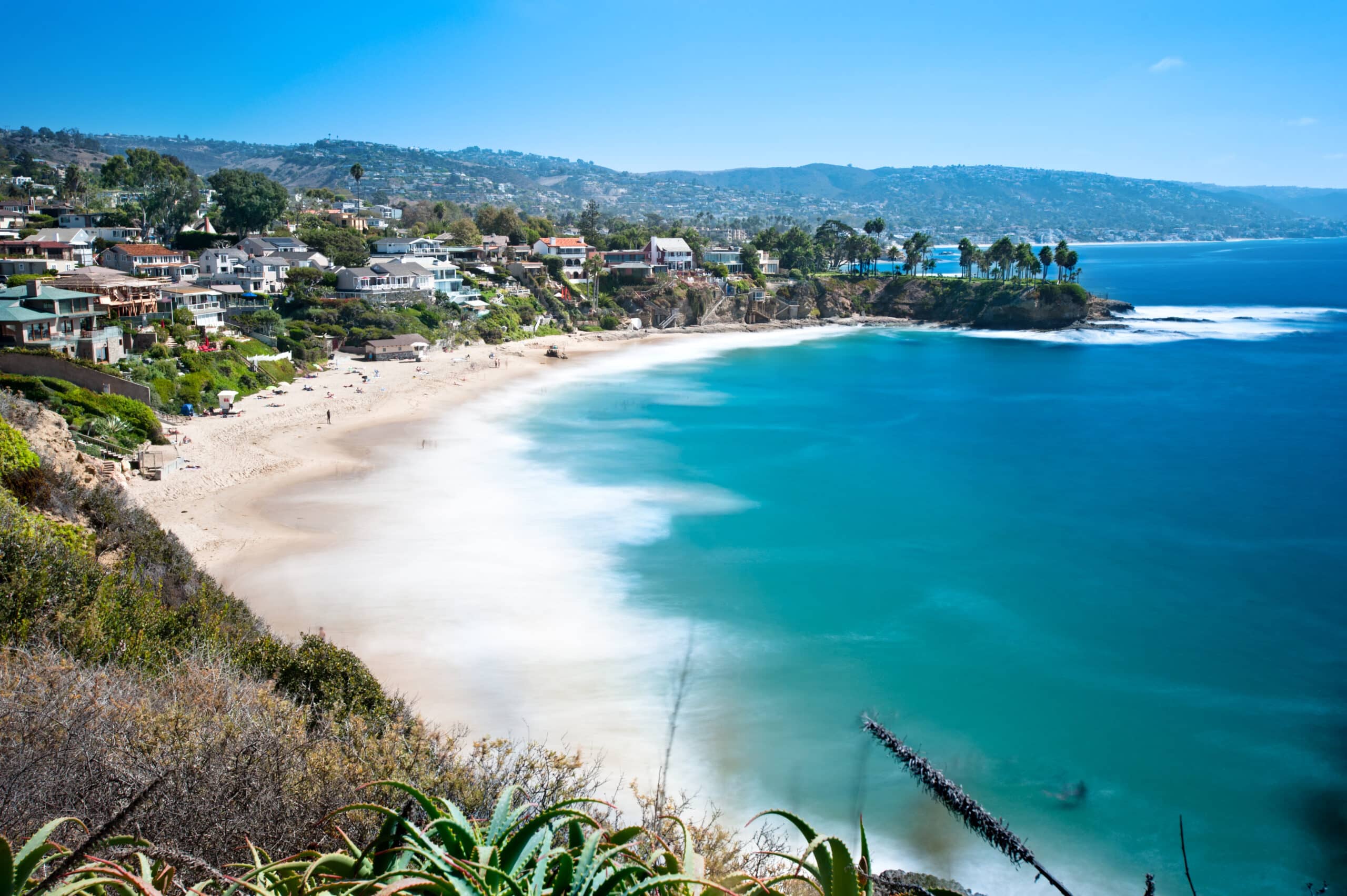 An image of a beautiful cove called Crescent Bay in Laguna Beach, California. Shot with a slow shutter to capture the water motion on a bright sunny day.